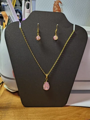 Handmade gold necklace with a pink teardrop pendant and matching earrings